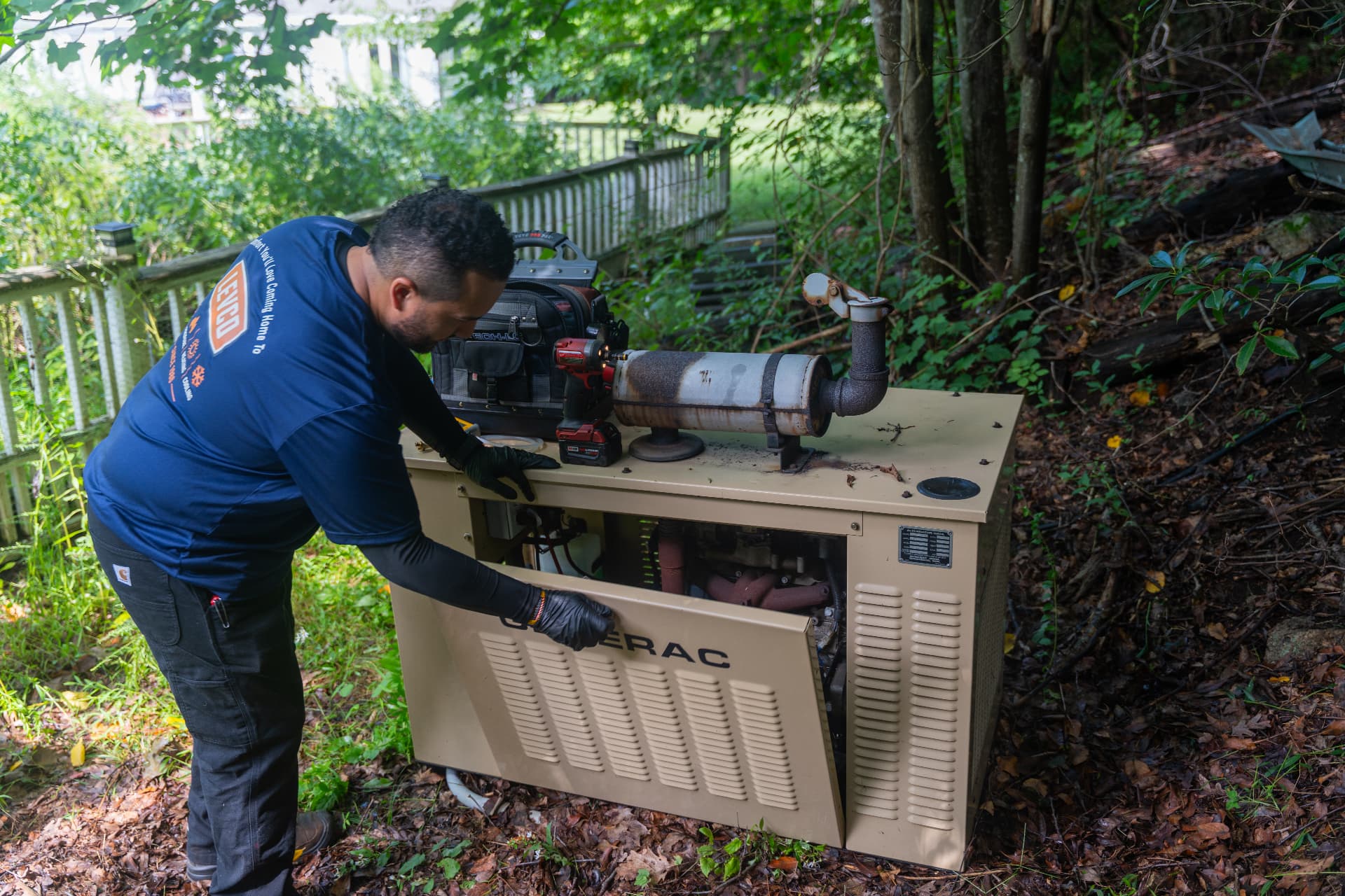 Levco technician connecting propane gas lines to a standby generator at a Connecticut home