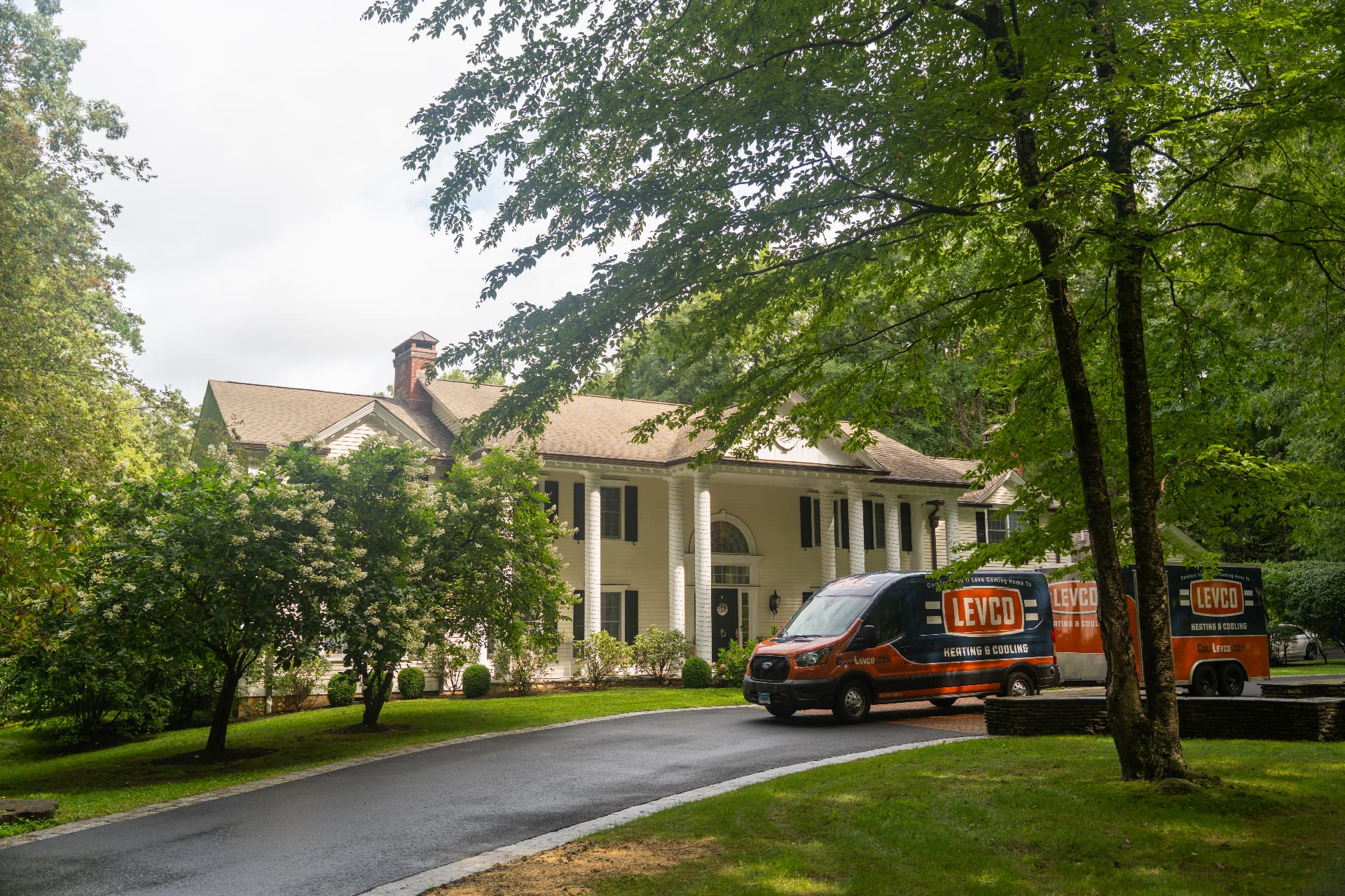 Levco van and trailer in the circular driveway of a Connecticut colonial home