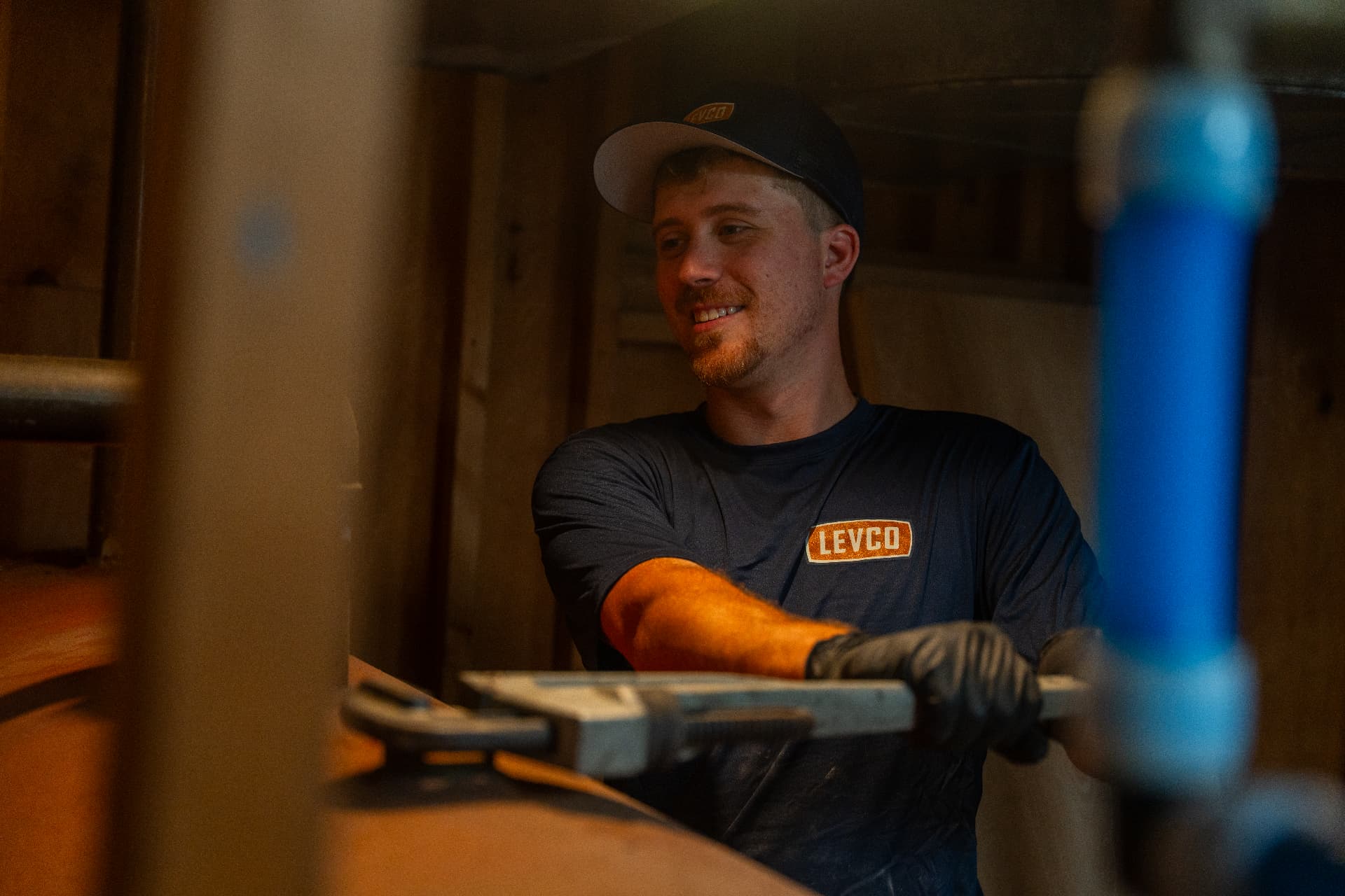 Levco technician servicing the fittings on a basement heating oil tank