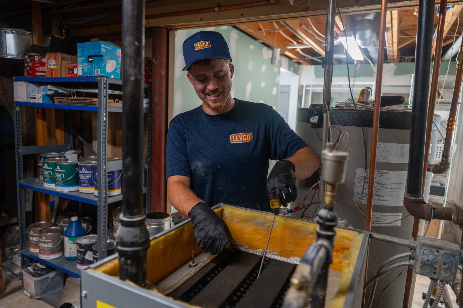 Levco technician cleaning the inside of an oil boiler during preventative maintenance