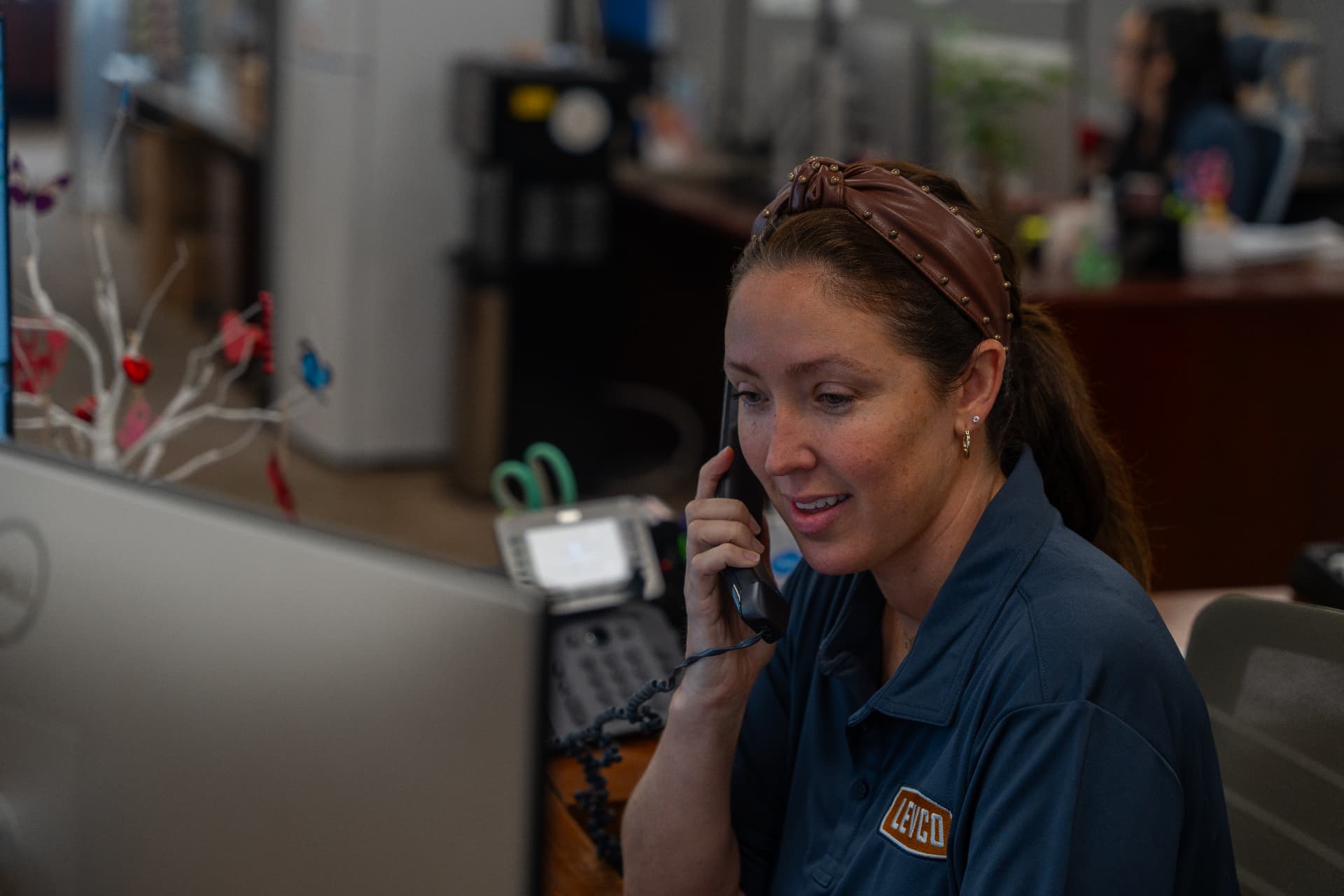 Levco team member on the phone with a homeowner at the Trumbull office