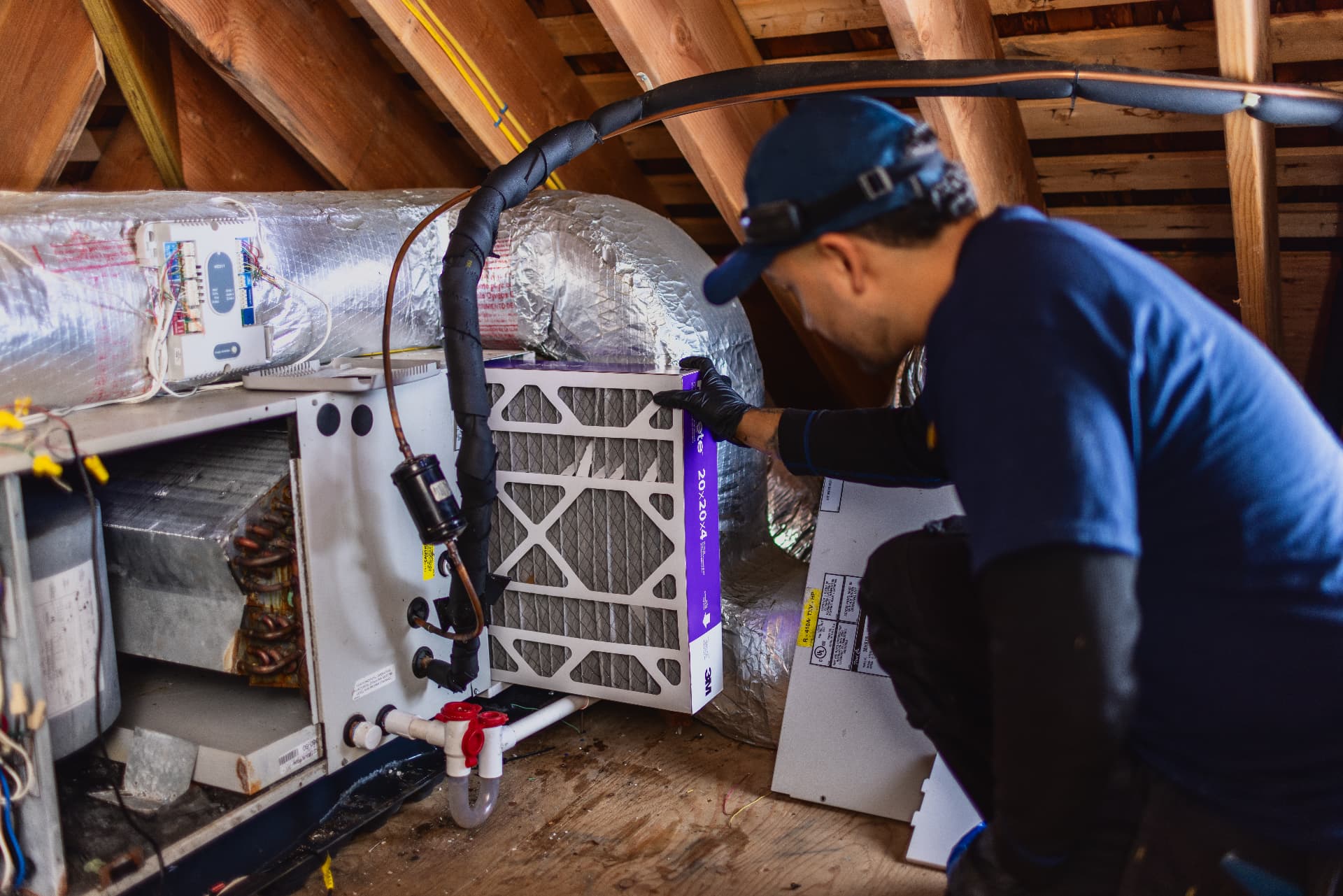 Levco technician checking the air filter at an attic cooling system