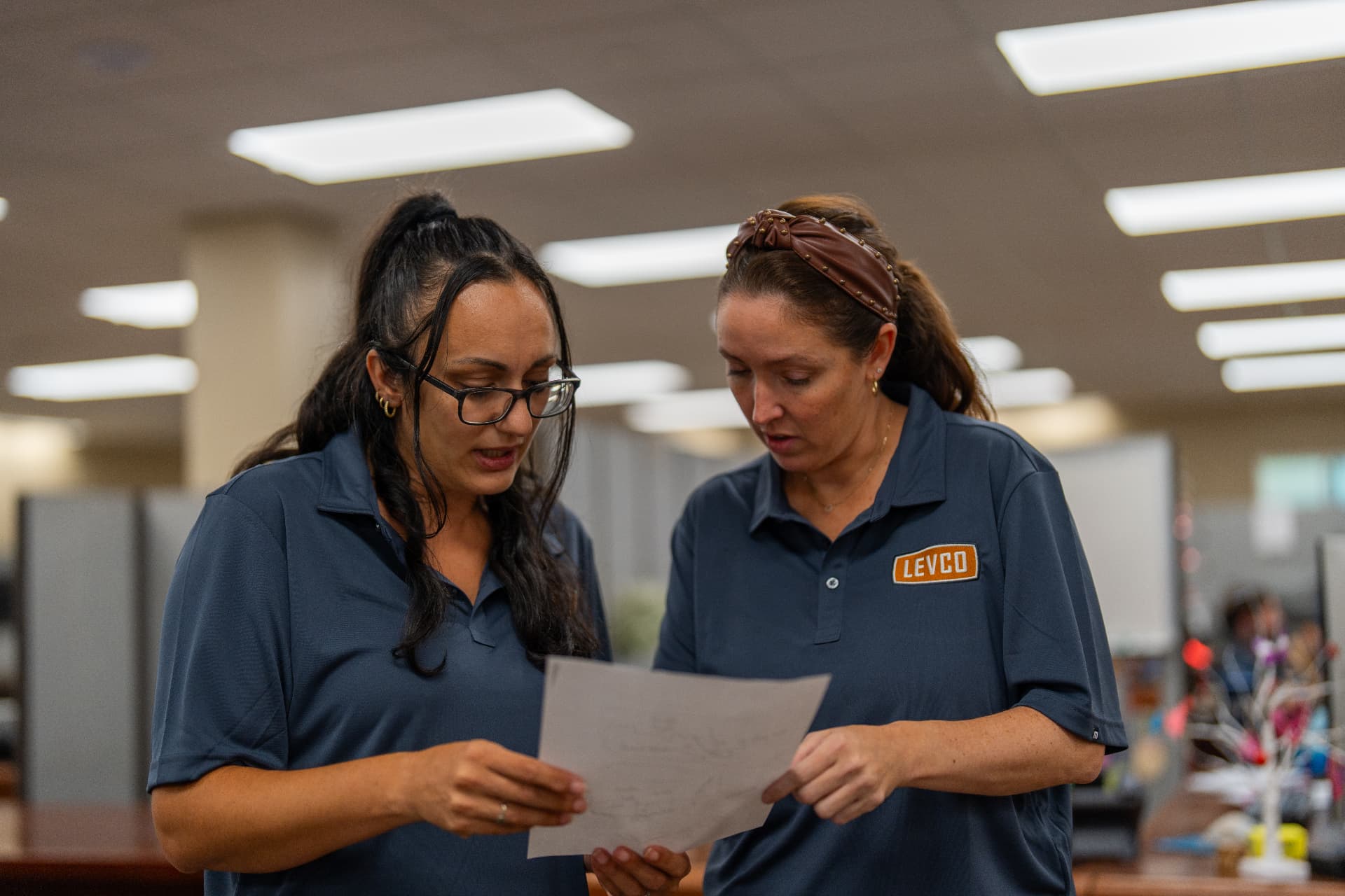 Two Levco team members reviewing water heater options together at the office